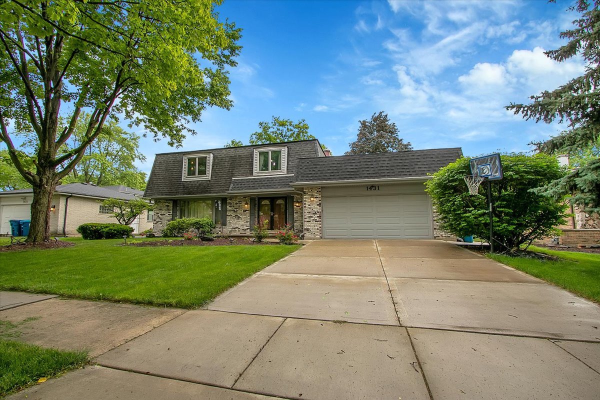 a view of house with outdoor space and garden