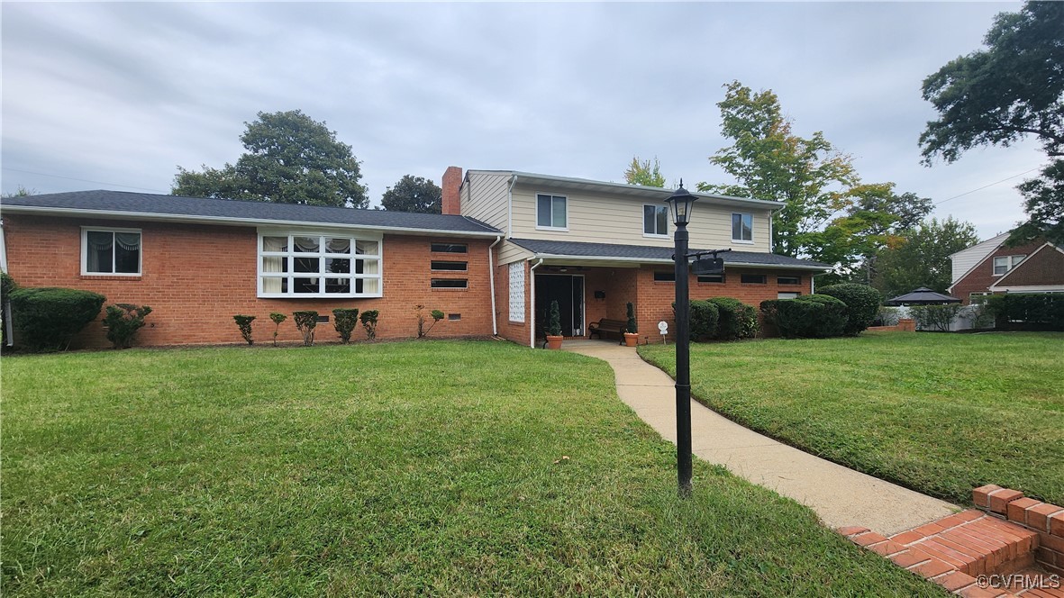 a front view of house with yard and green space