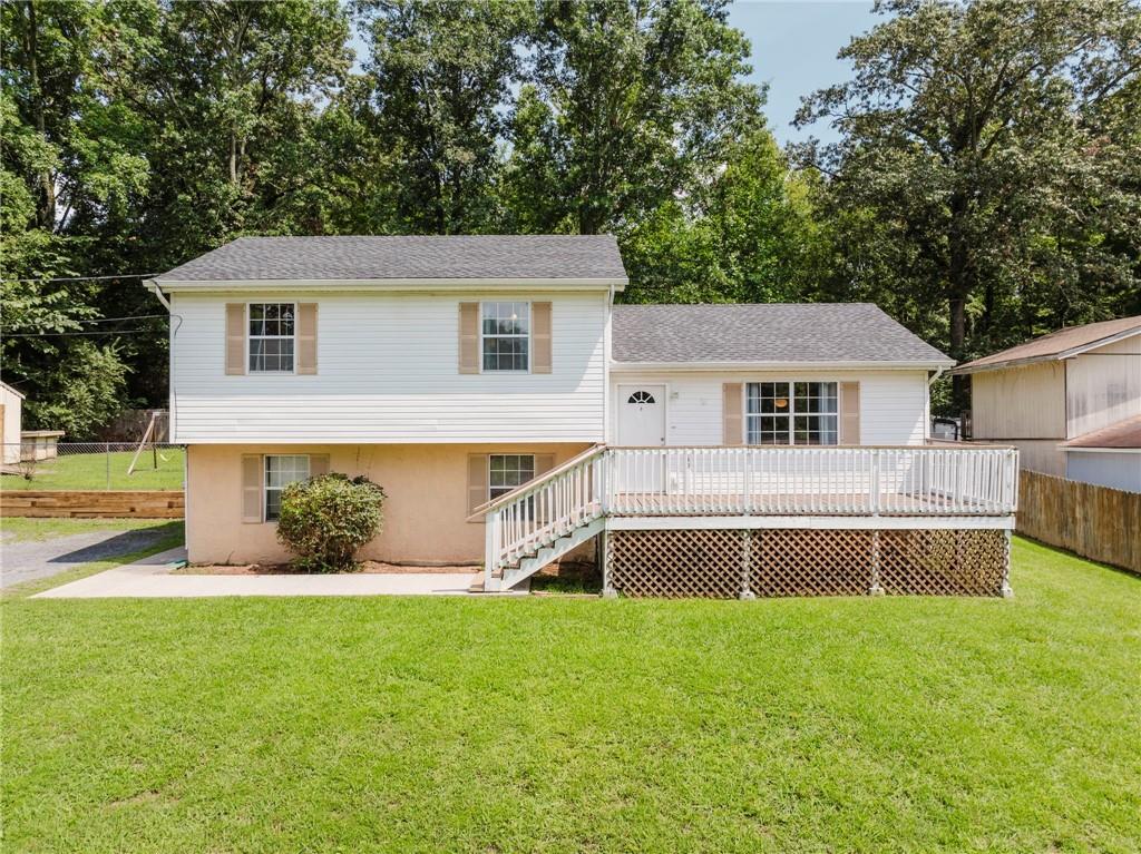 a view of a house with a yard and sitting area