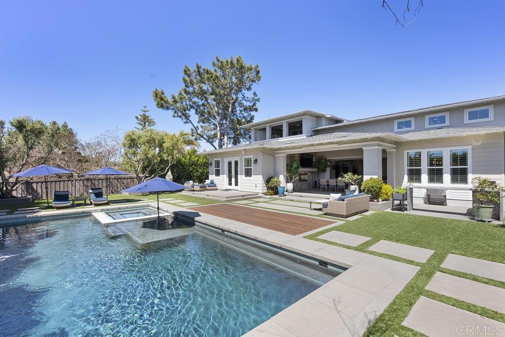 a view of a house with swimming pool and sitting area