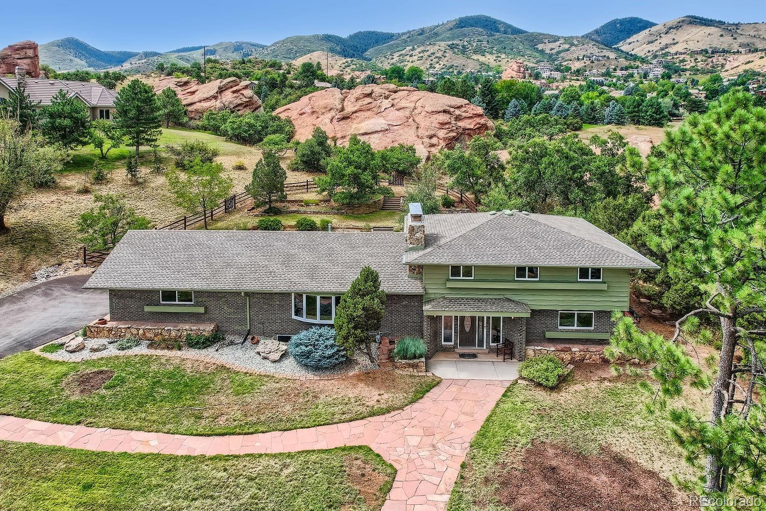 an aerial view of a house with garden space and a patio