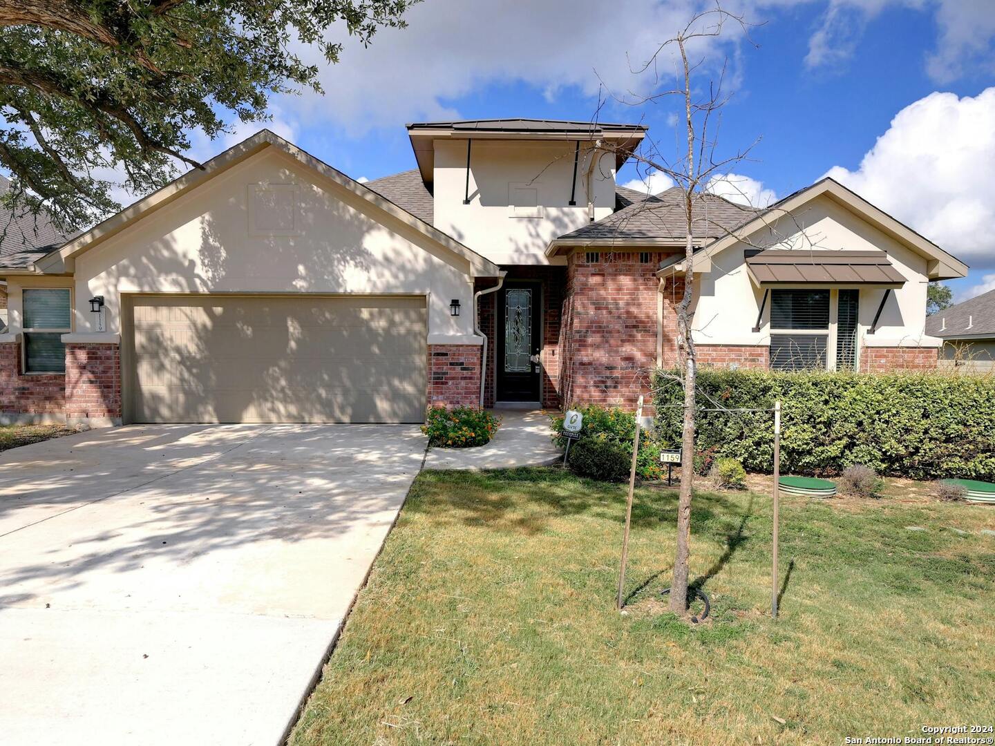 a front view of a house with a yard