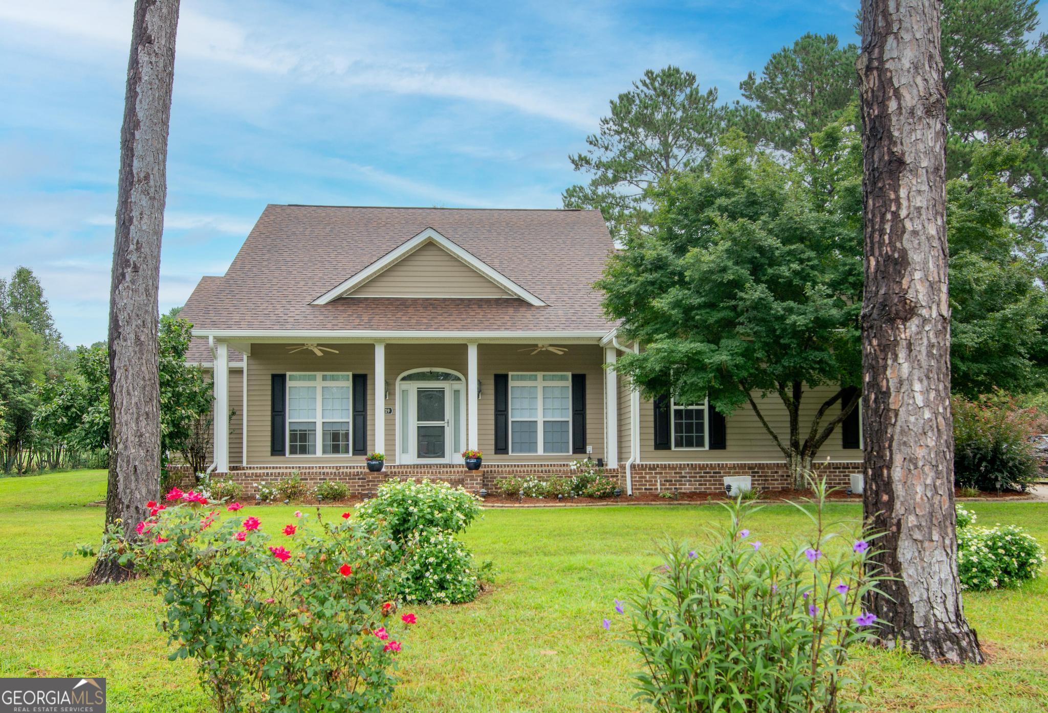 a front view of a house with garden