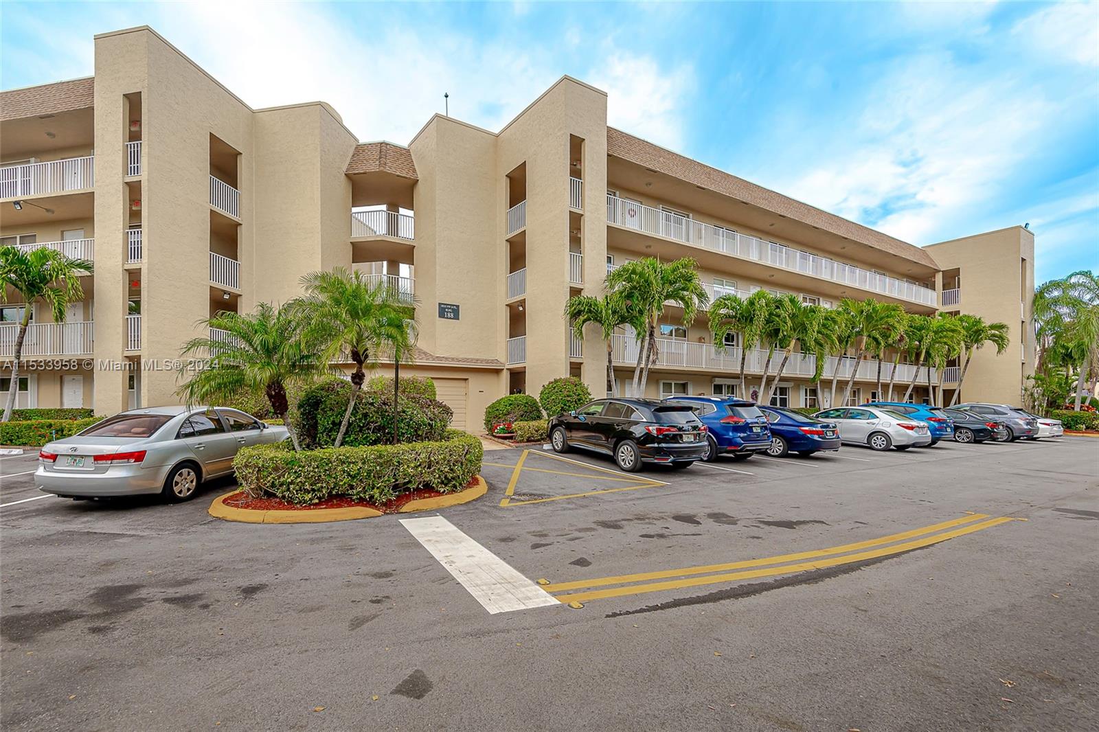 a view of a cars park in front of a building