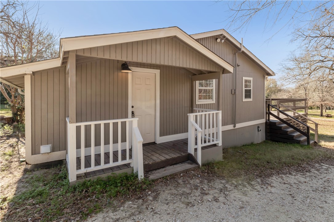 a view of a house with a yard and deck