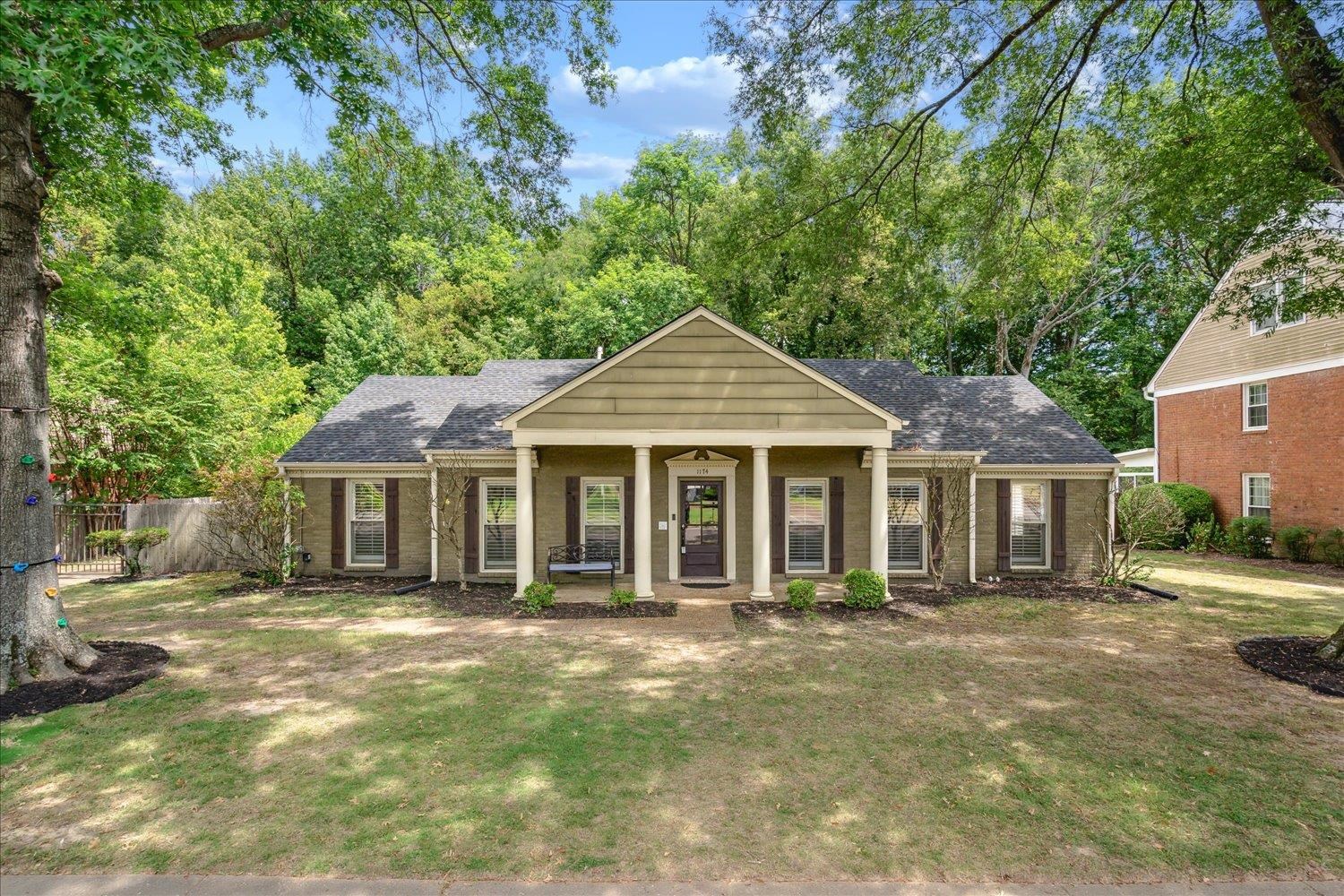 a front view of a house with a garden