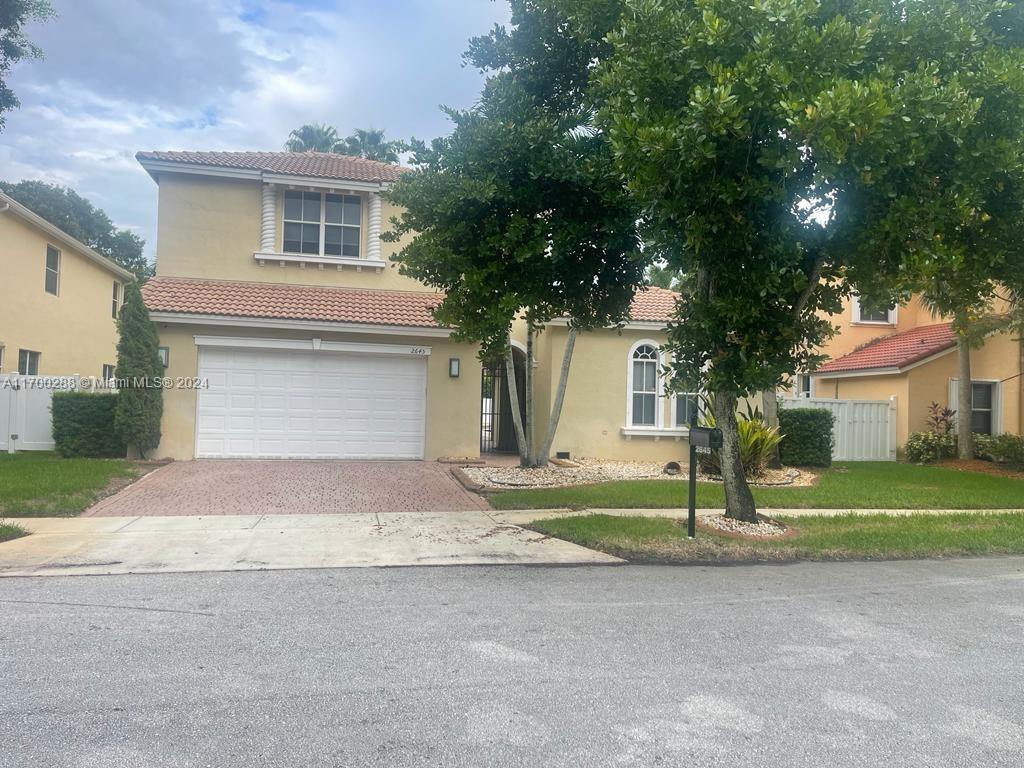 a front view of a house with a yard and garage