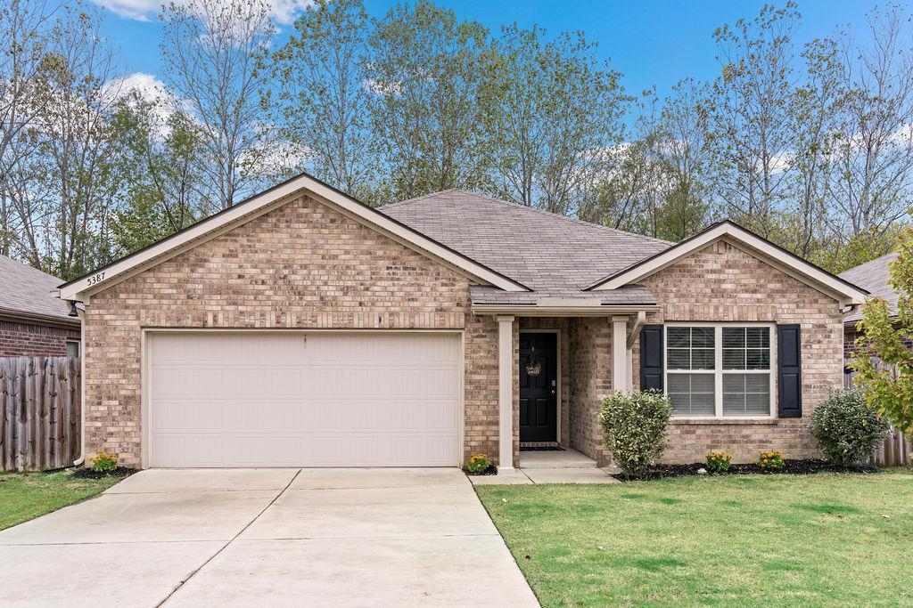 View of front of property with a garage and a front yard