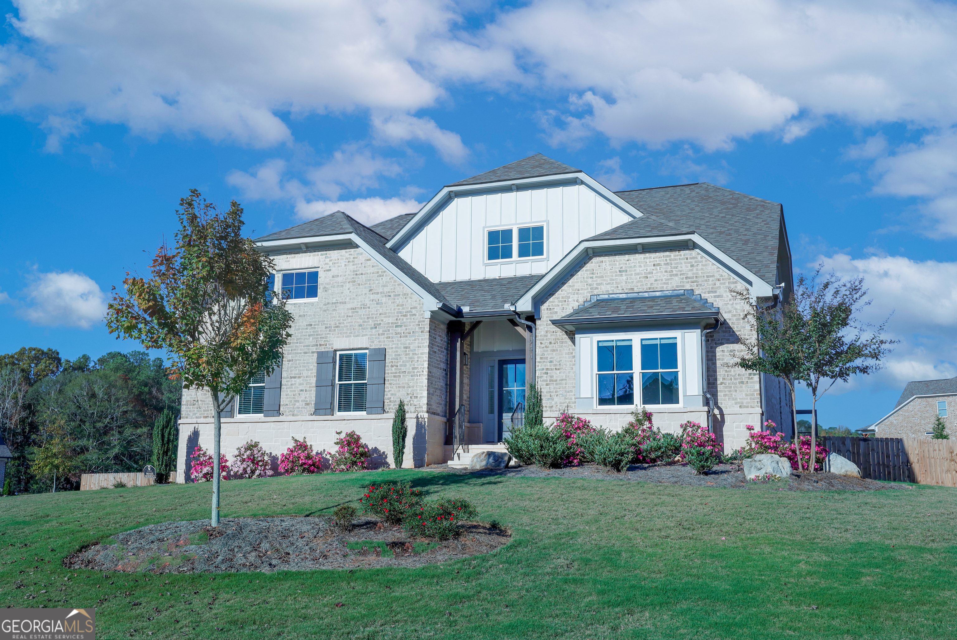 a front view of a house with a garden