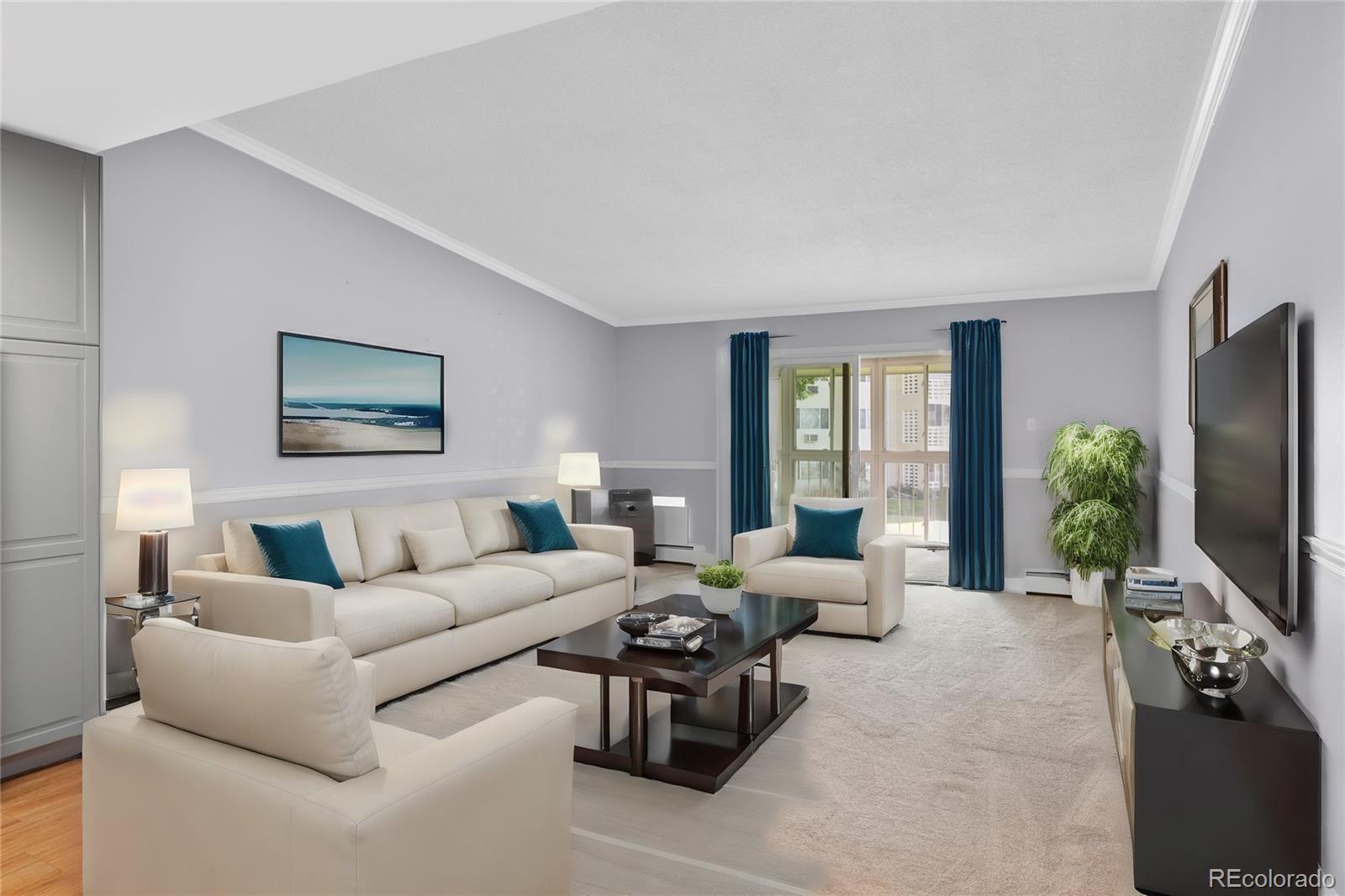 a living room with furniture potted plant and a flat screen tv