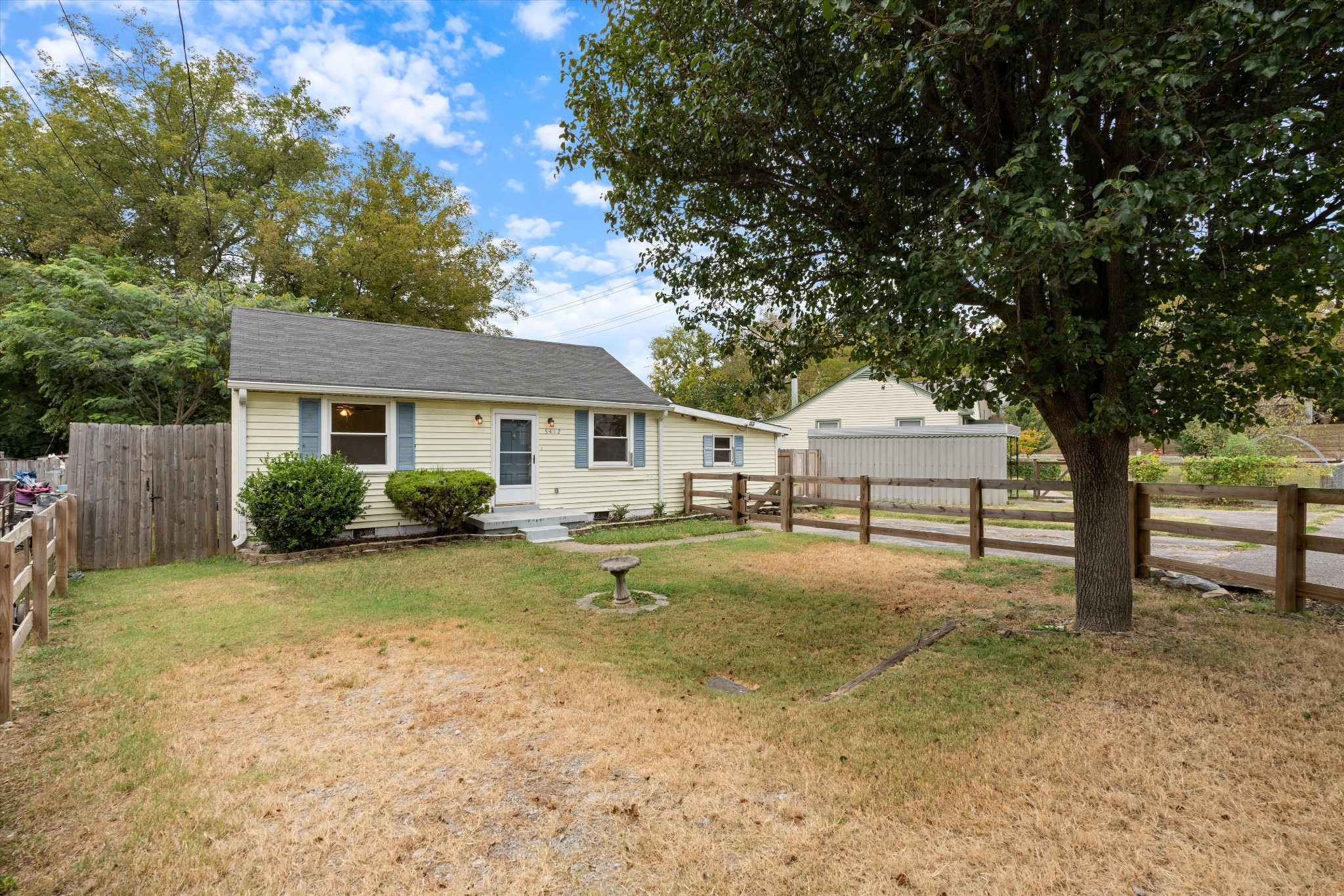 a view of a yard with a house and tree s