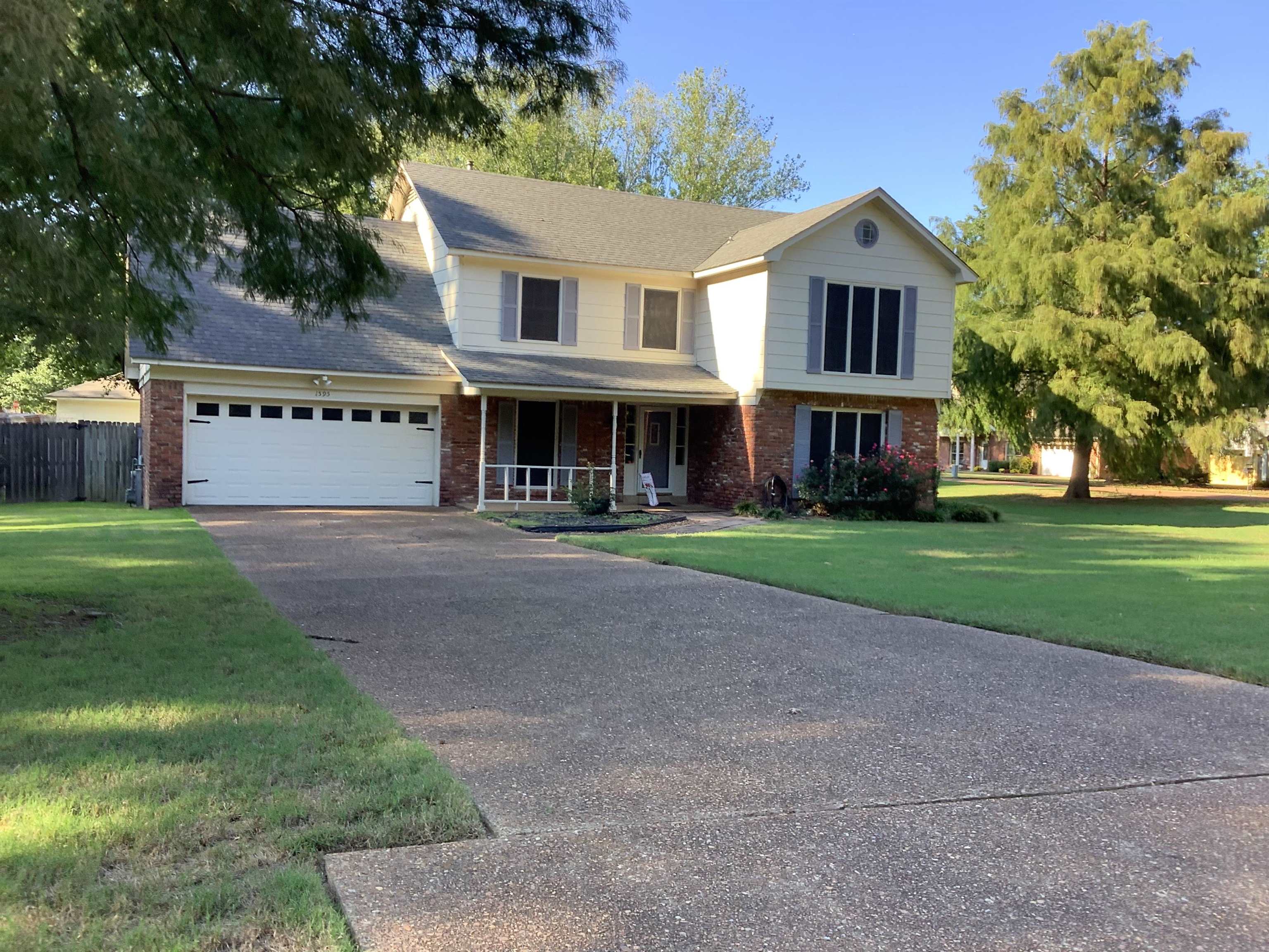 a front view of house with yard and green space