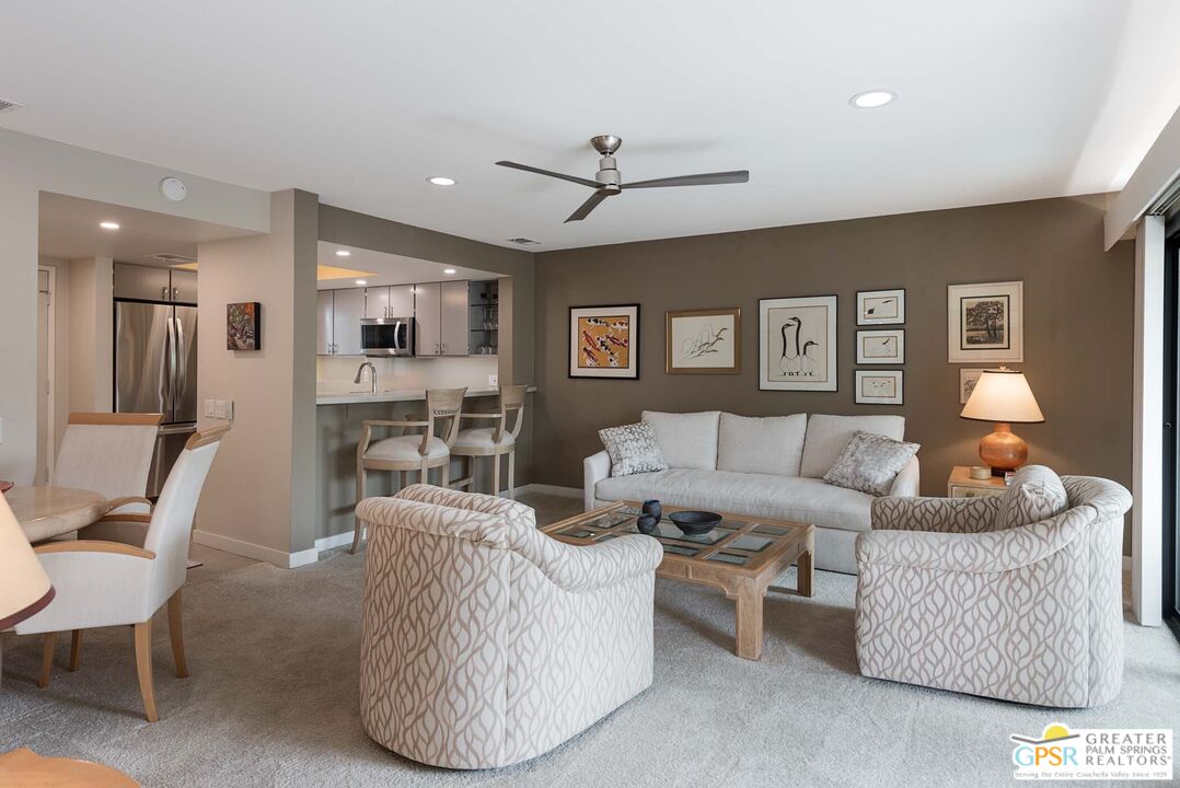 a living room with furniture and kitchen view