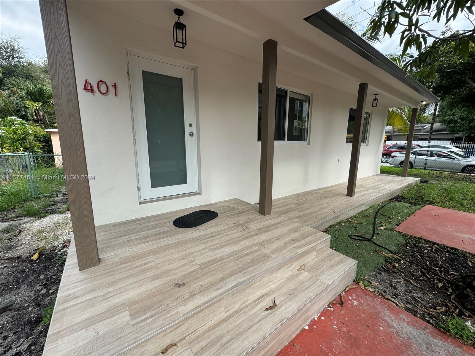 a view of a house with backyard porch and sitting area