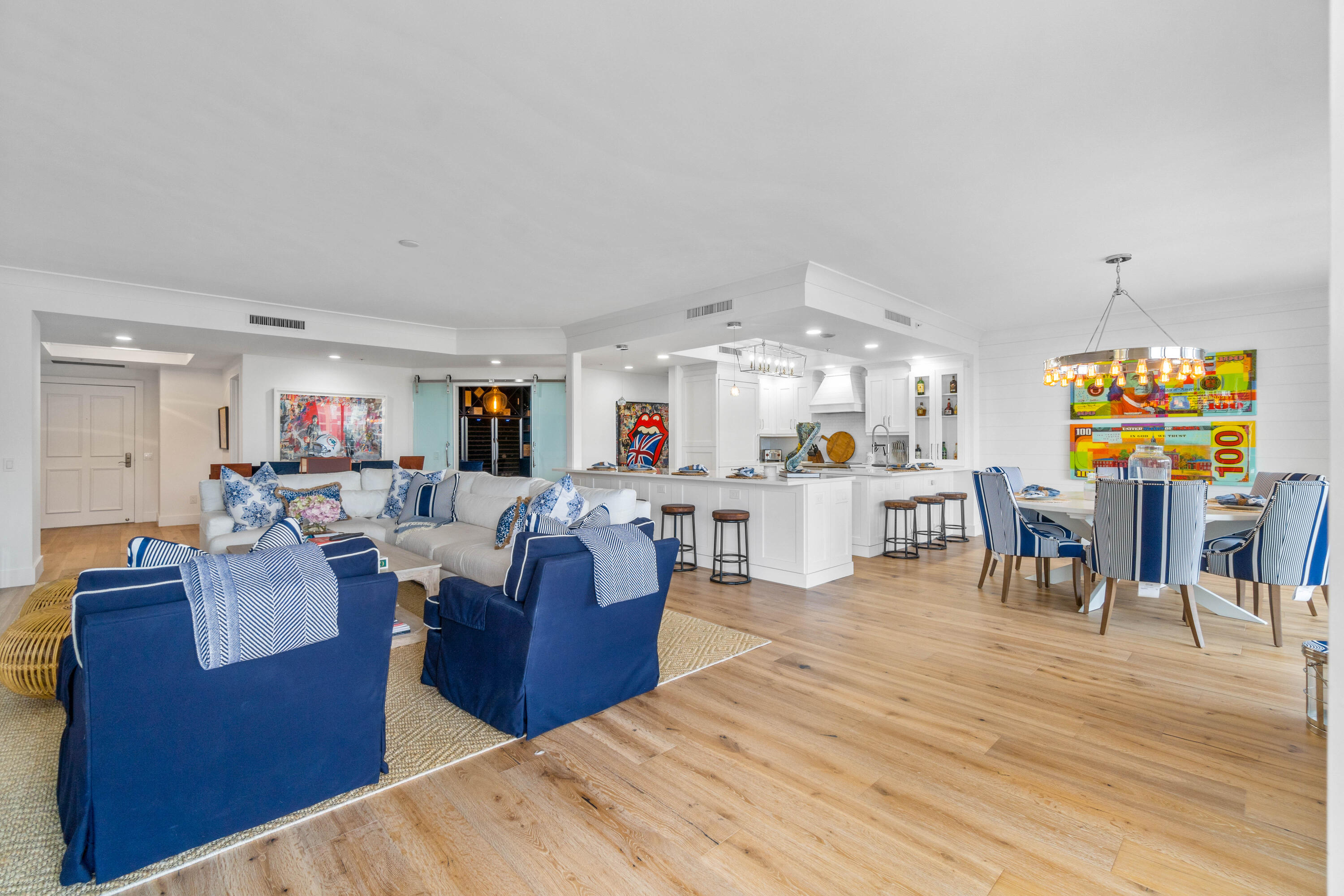 a living room with lots of furniture and kitchen view