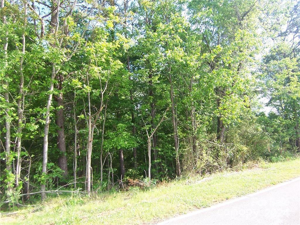 a view of a wooden fence and trees