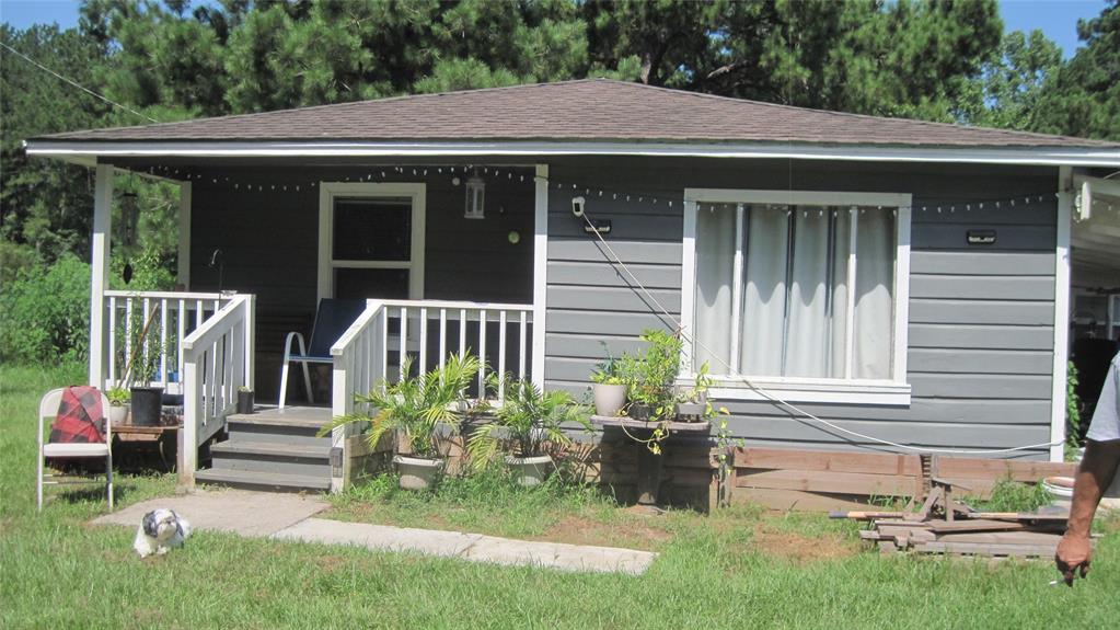 a front view of a house with a yard table and chairs