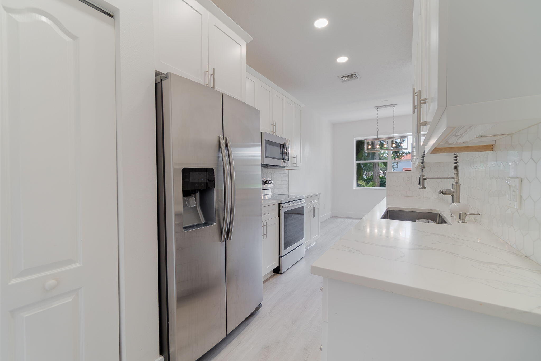 a kitchen with stainless steel appliances a refrigerator and a sink