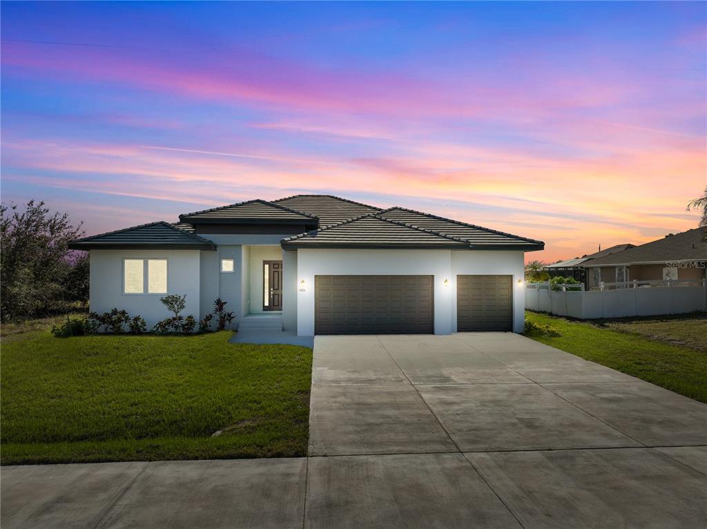 a front view of a house with a yard and garage