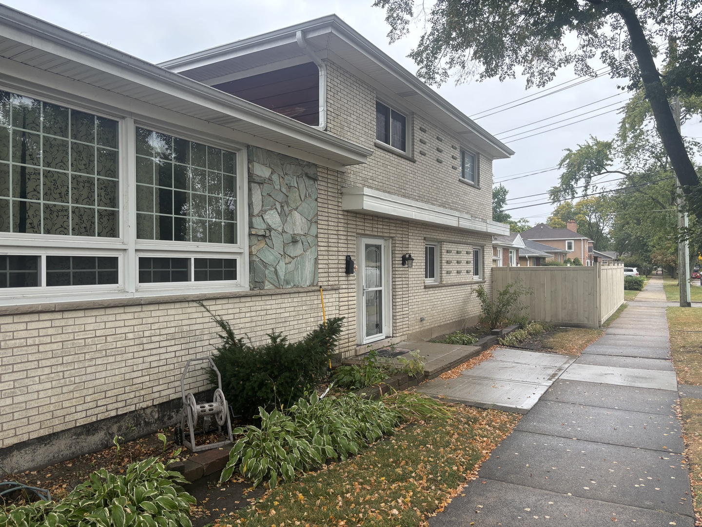 a front view of a house with a garden