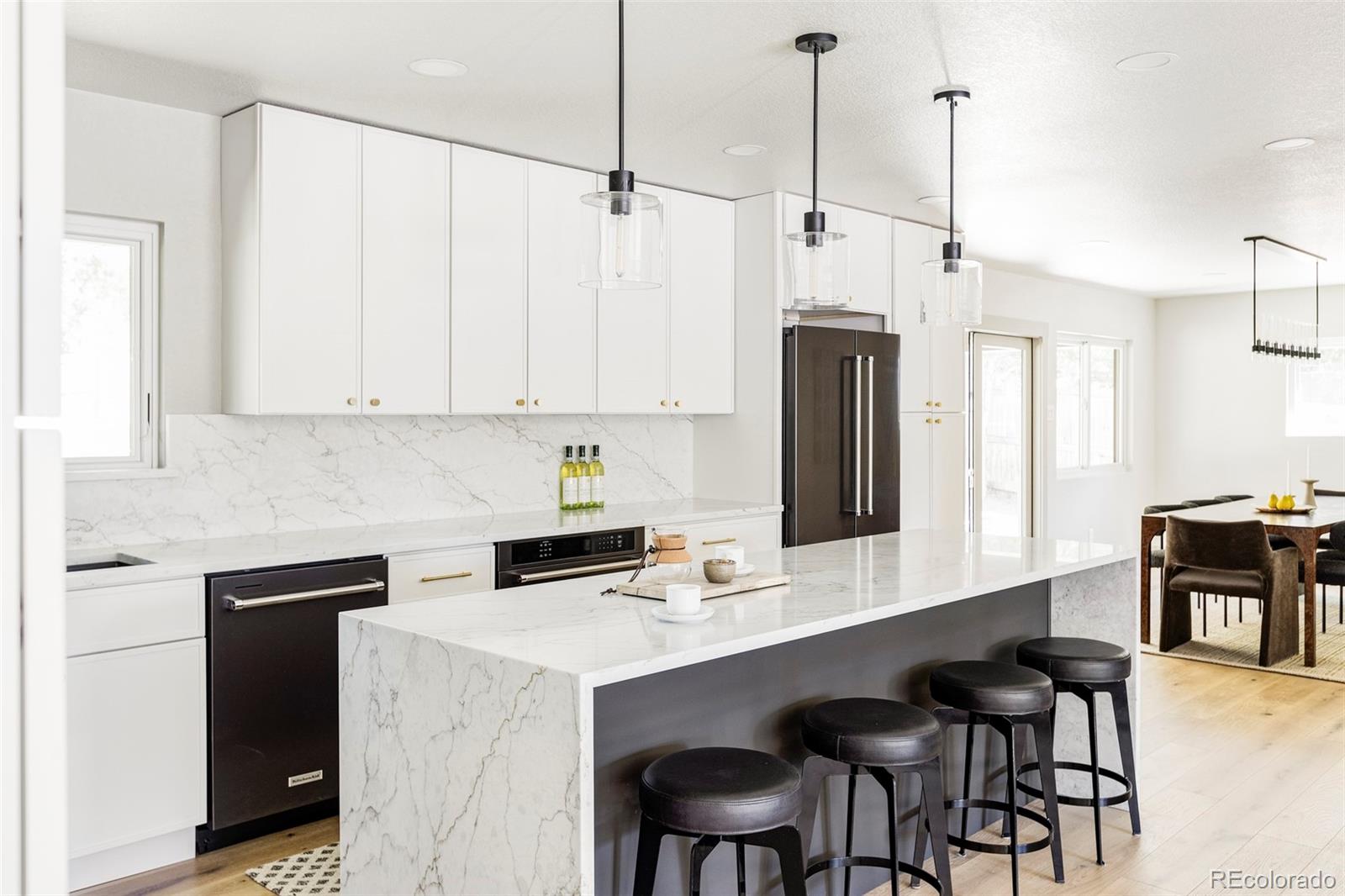 a kitchen with stainless steel appliances white cabinets and a refrigerator