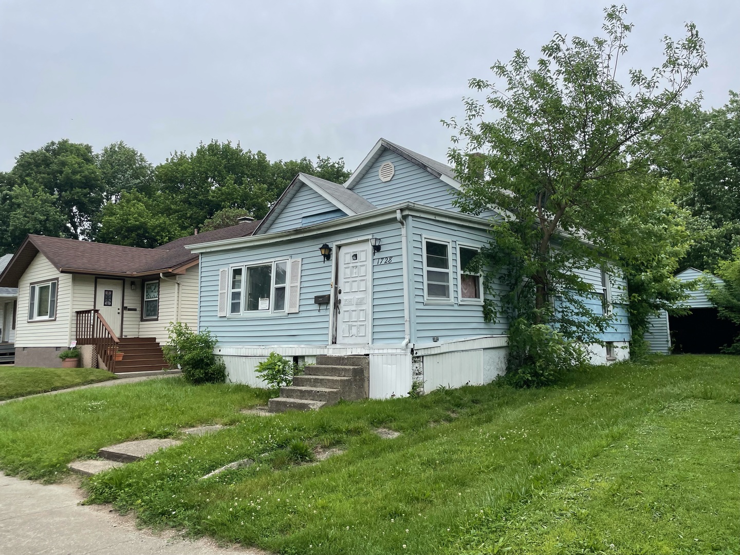 a front view of house with yard and green space