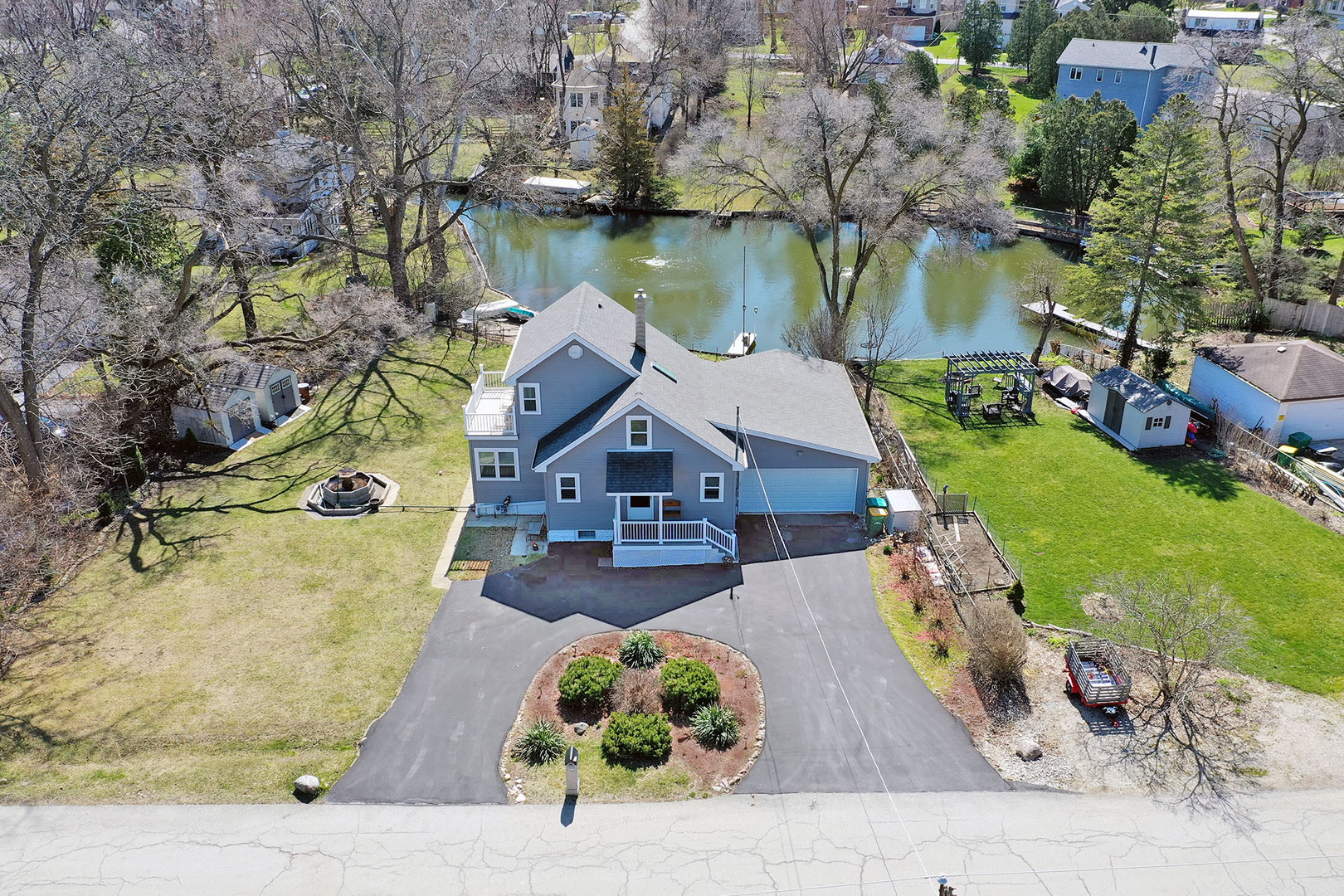 an aerial view of a house with a garden and lake view