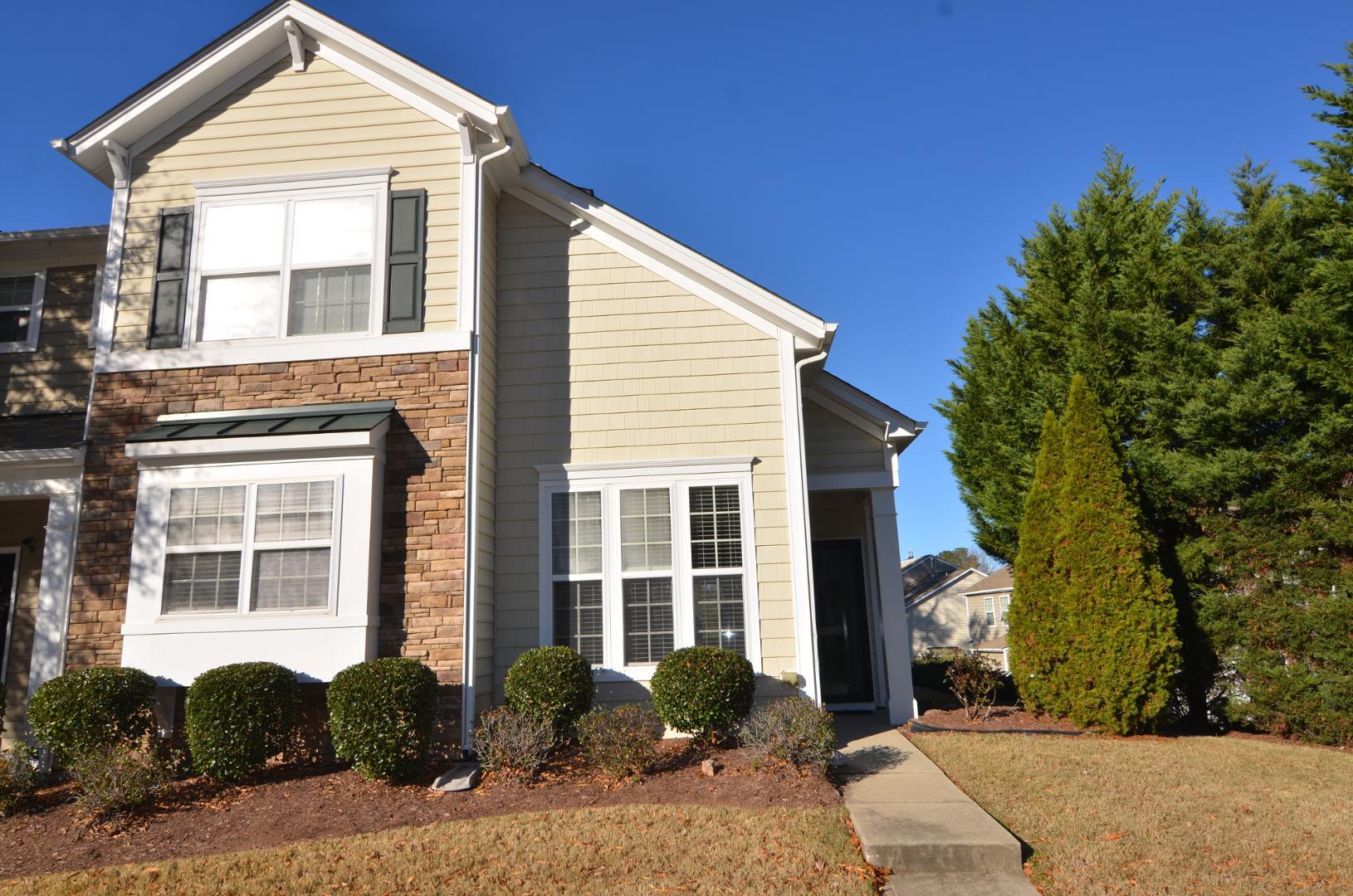 a front view of a house with garden