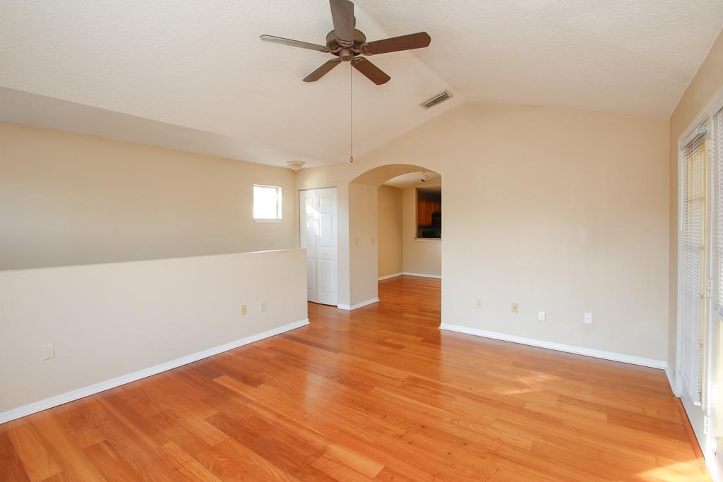 a view of empty room with ceiling fan