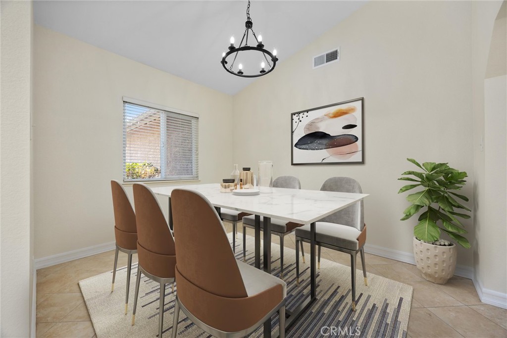 a dining room with furniture potted plants and wooden floor