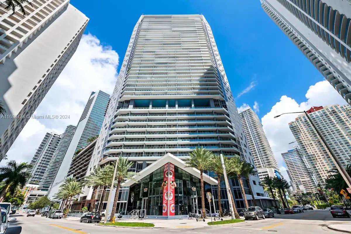 a view of a tall building next to a road