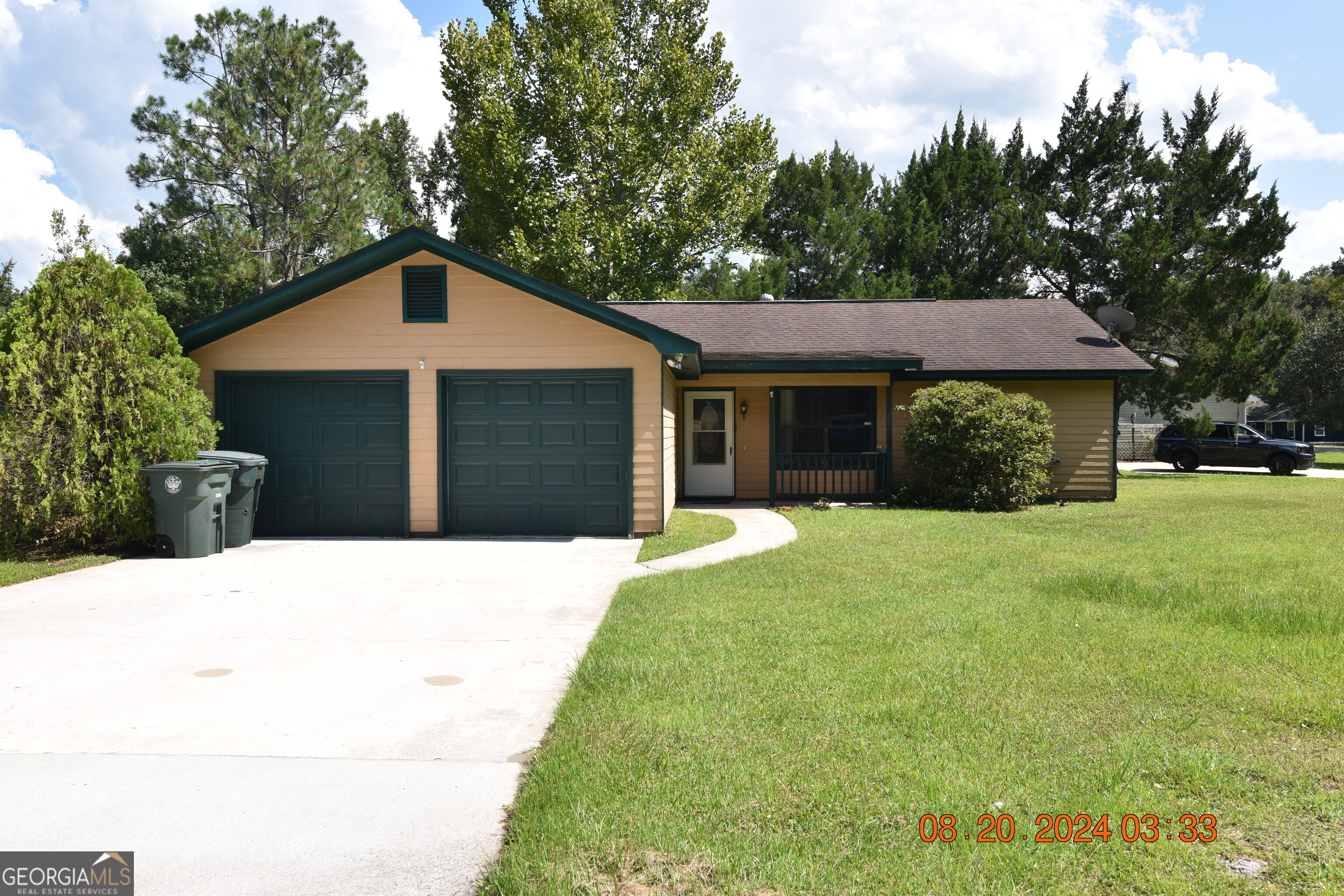 a front view of a house with a garden