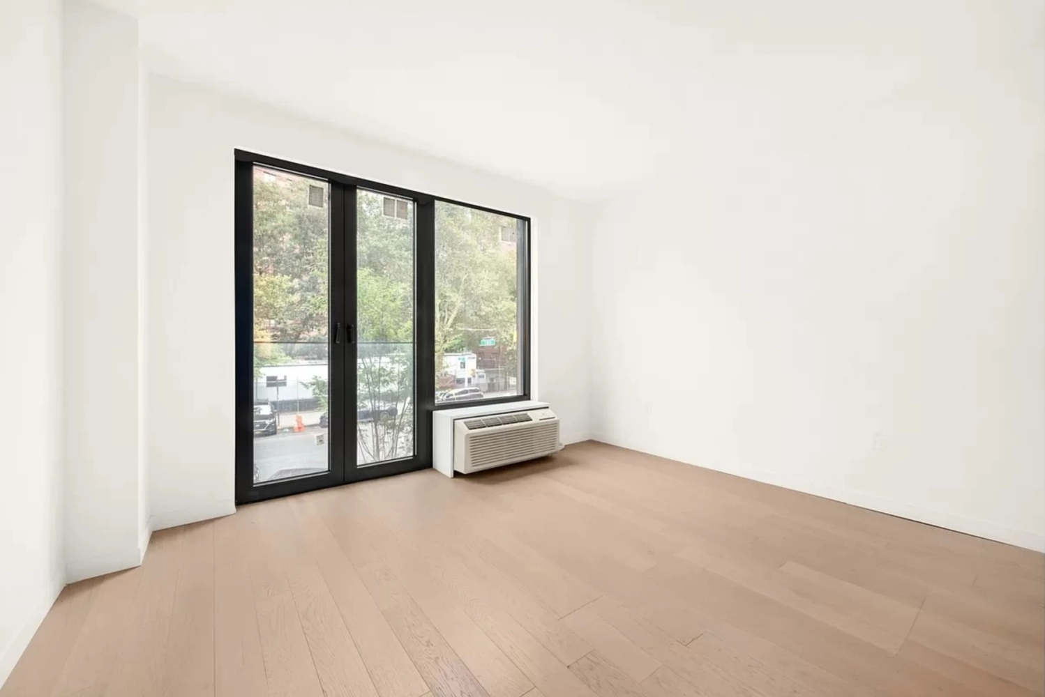 a view of an empty room with a large window