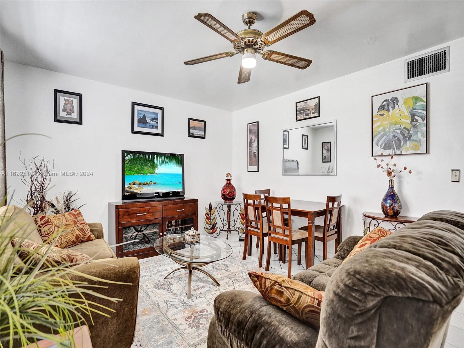 a living room with furniture a couch and a flat screen tv