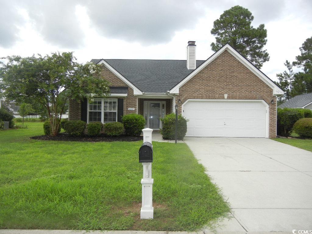 Ranch-style house featuring a front yard