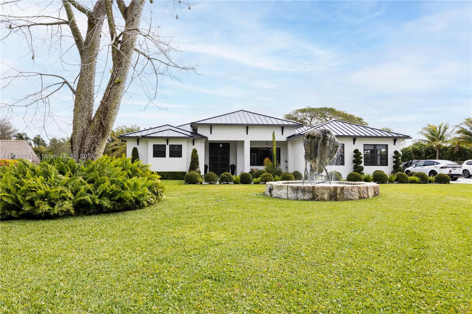 a front view of a house with swimming pool having outdoor seating