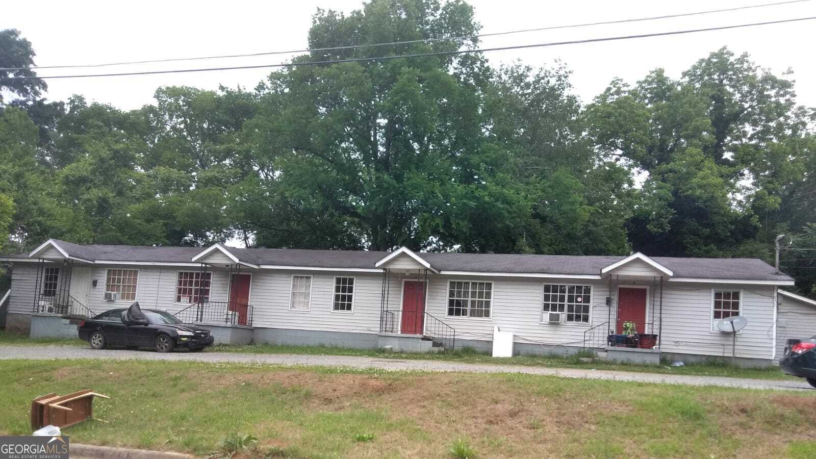 a front view of a house with a garden