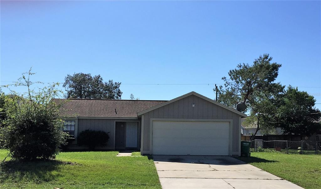 a front view of a house with a yard and a garage