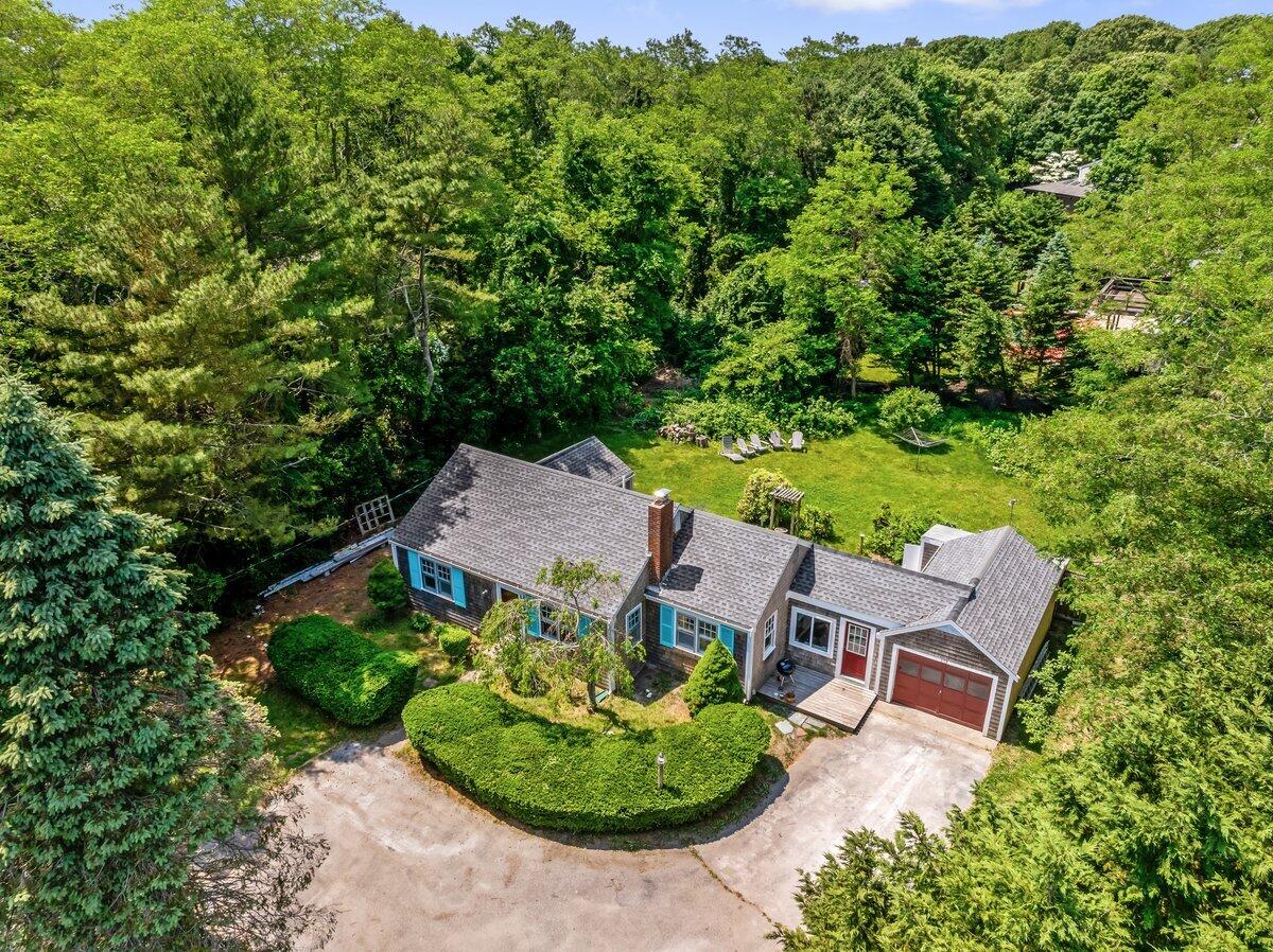 an aerial view of a house with garden space and street view