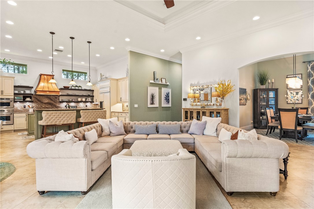 a living room with furniture and kitchen view