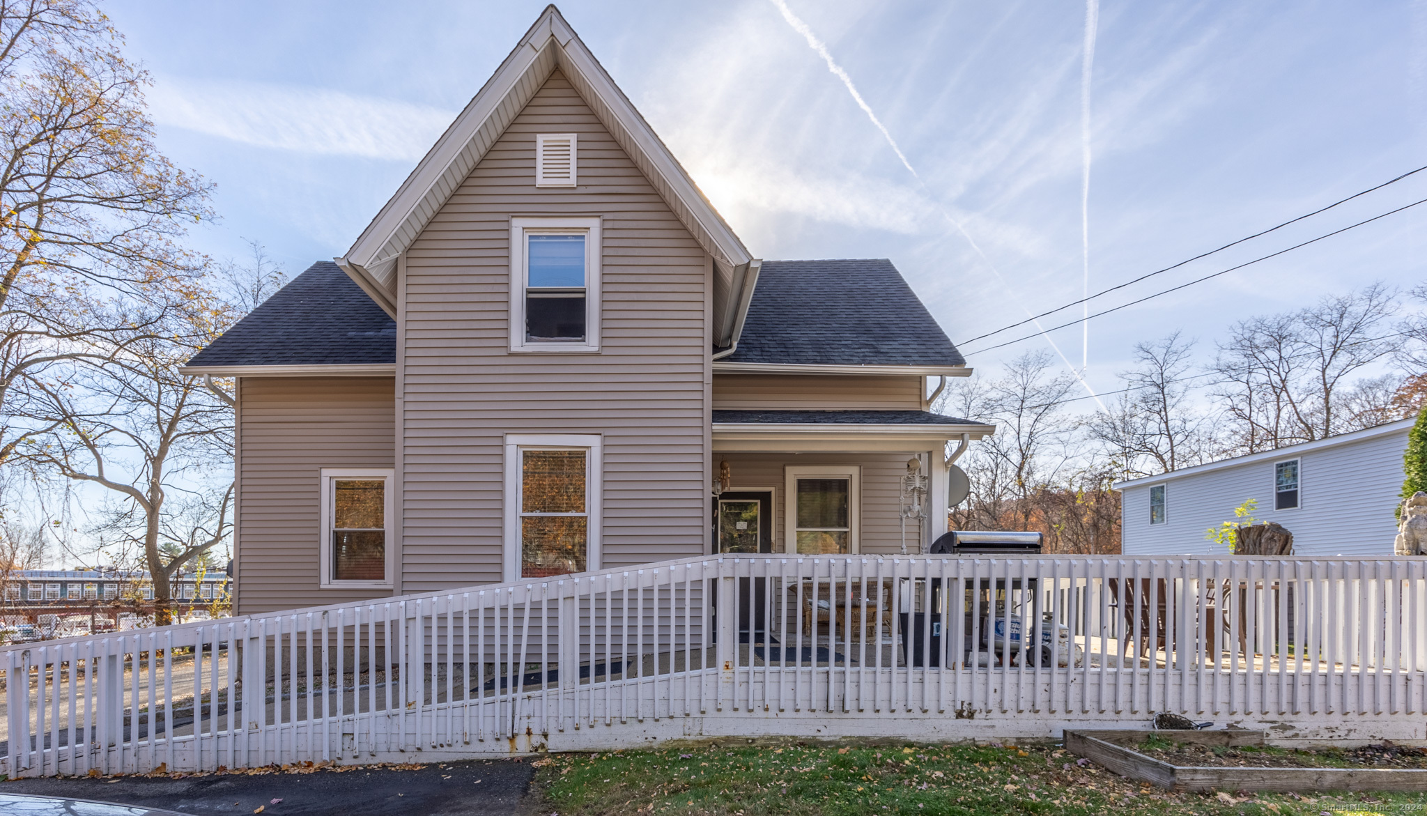 a view of a house with wooden fence