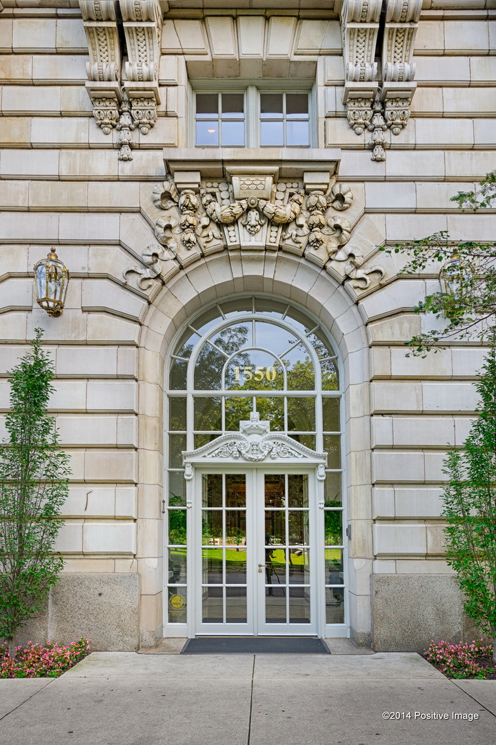 a front view of a building with a garden