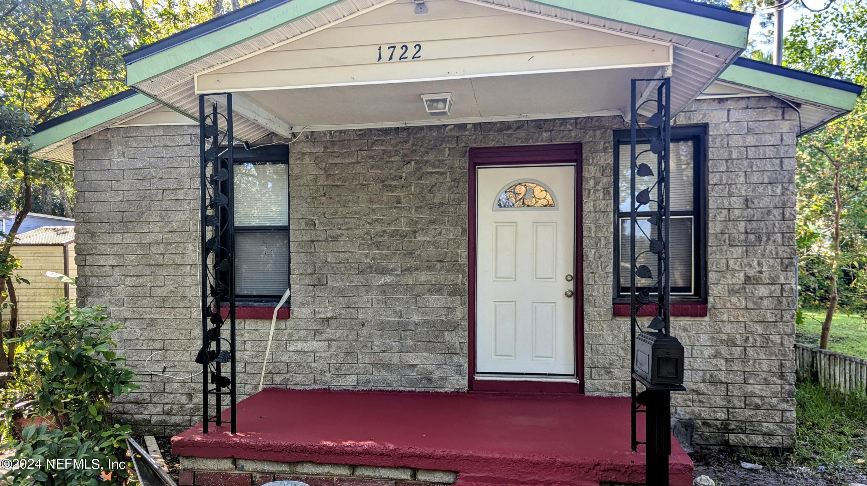 a front view of a house with a red gate