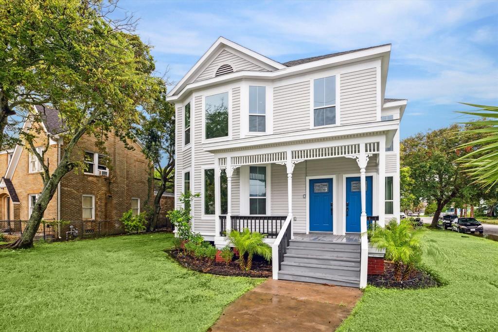 a front view of a house with garden and porch