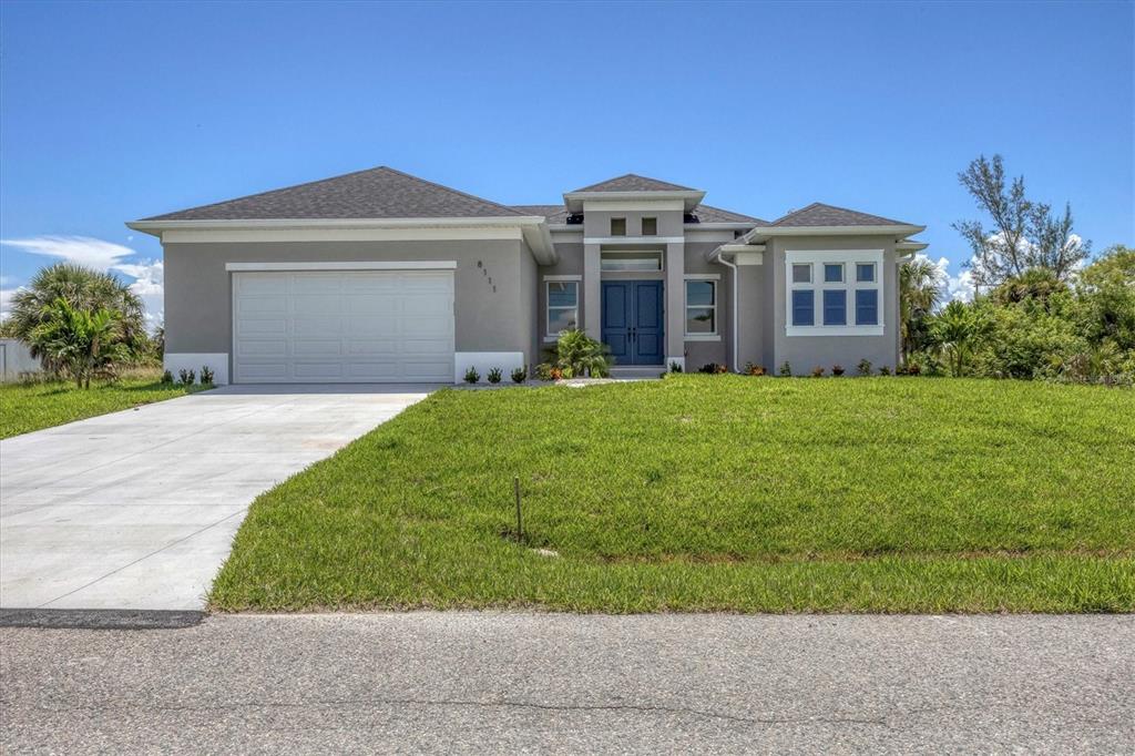 a front view of a house with a garden and yard