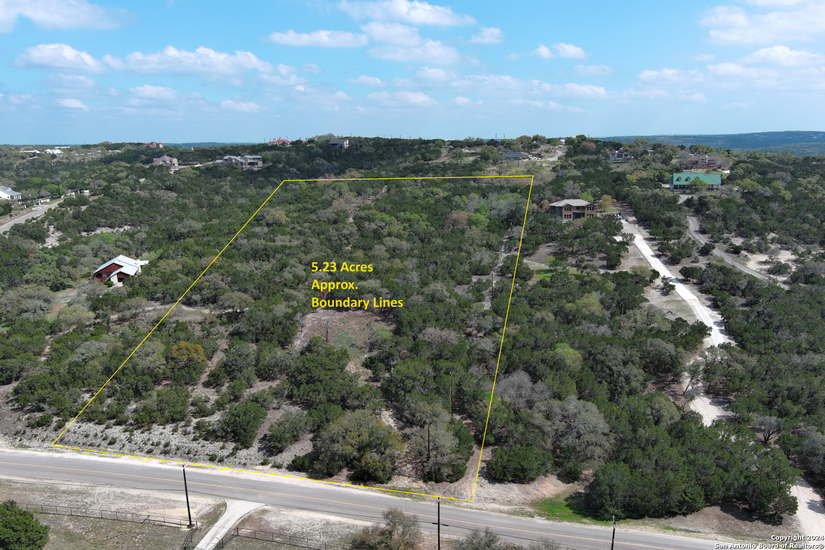 an aerial view of residential houses with city view