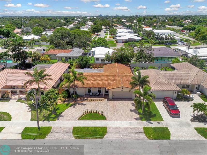 an aerial view of residential houses with outdoor space and street view