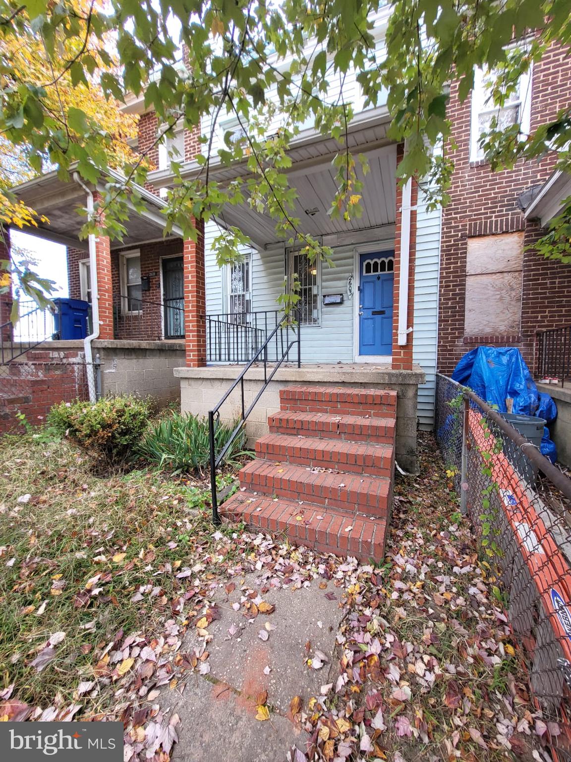 a front view of a house with a yard and outdoor seating