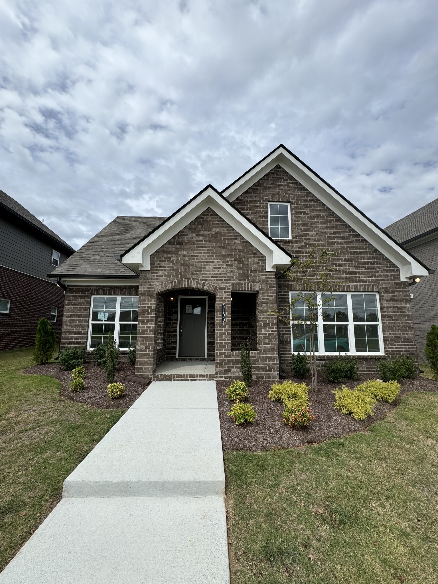 a front view of a house with garden