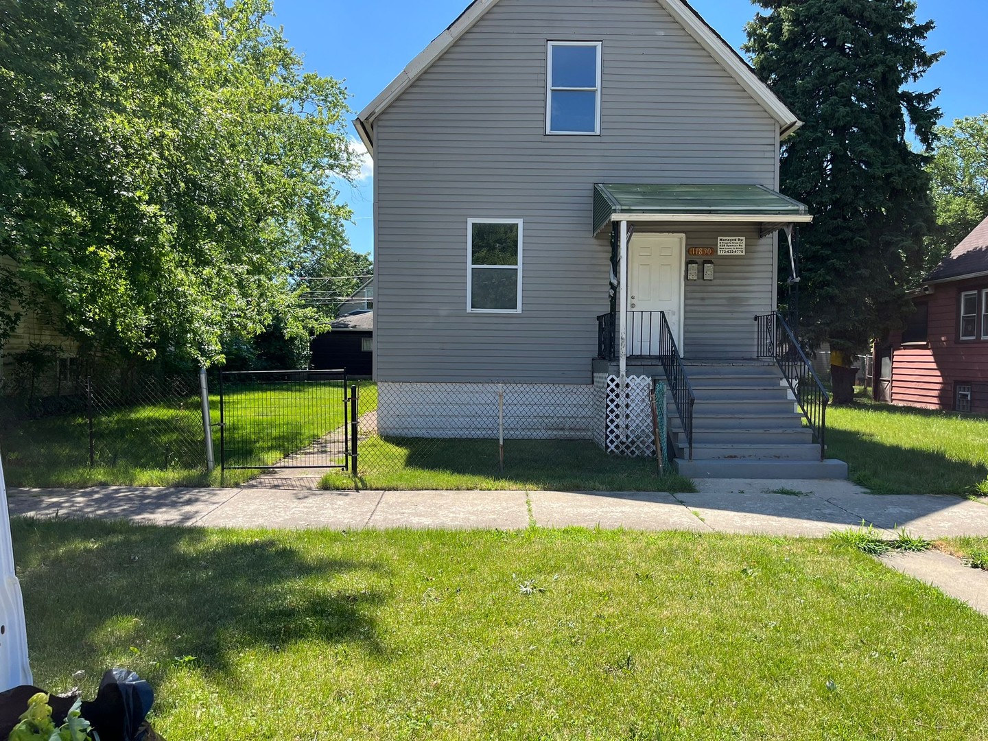 a view of a house with backyard and sitting area